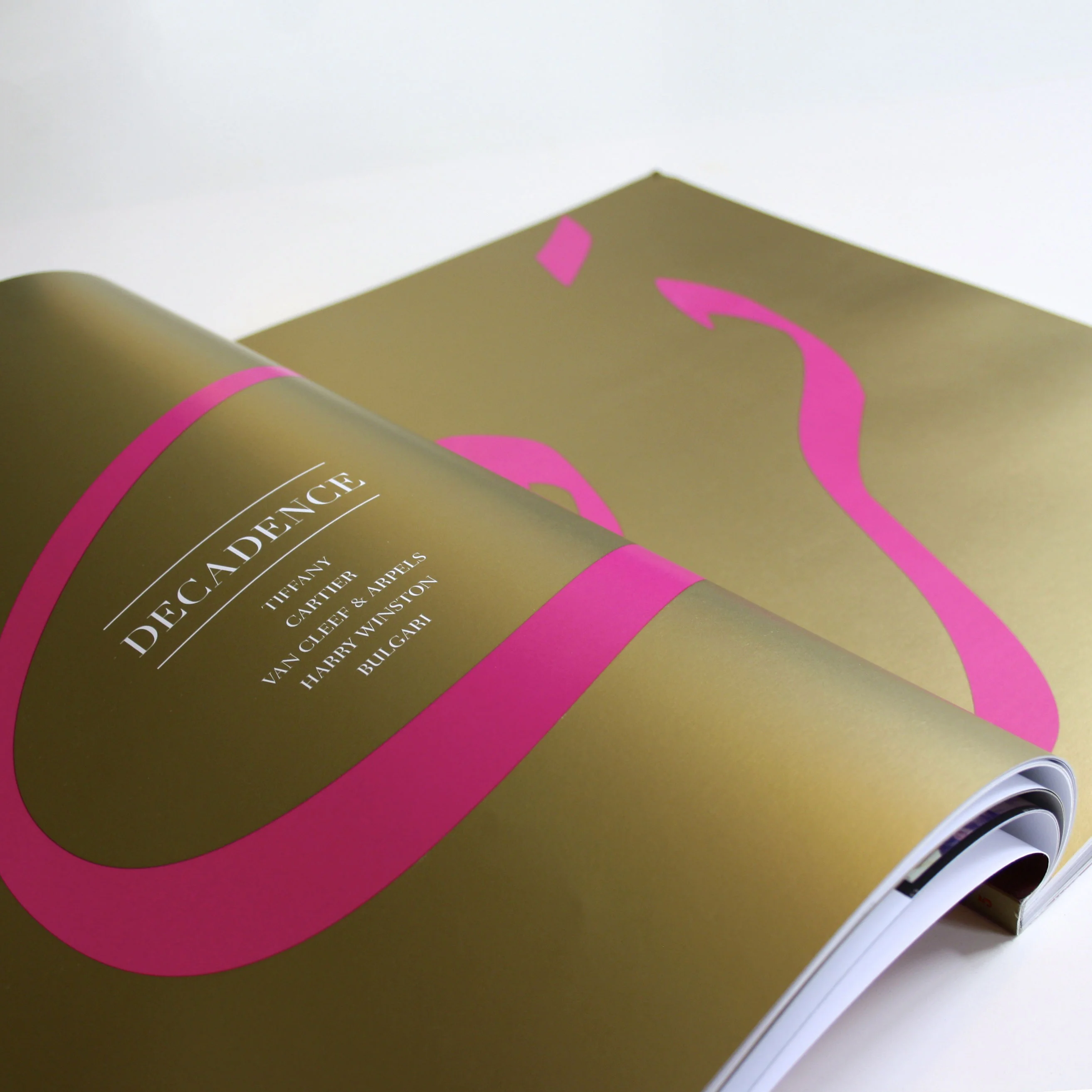 a photo of a gold section opening spread from Masquerade Magazines text in Arabic and English reads Decadence
