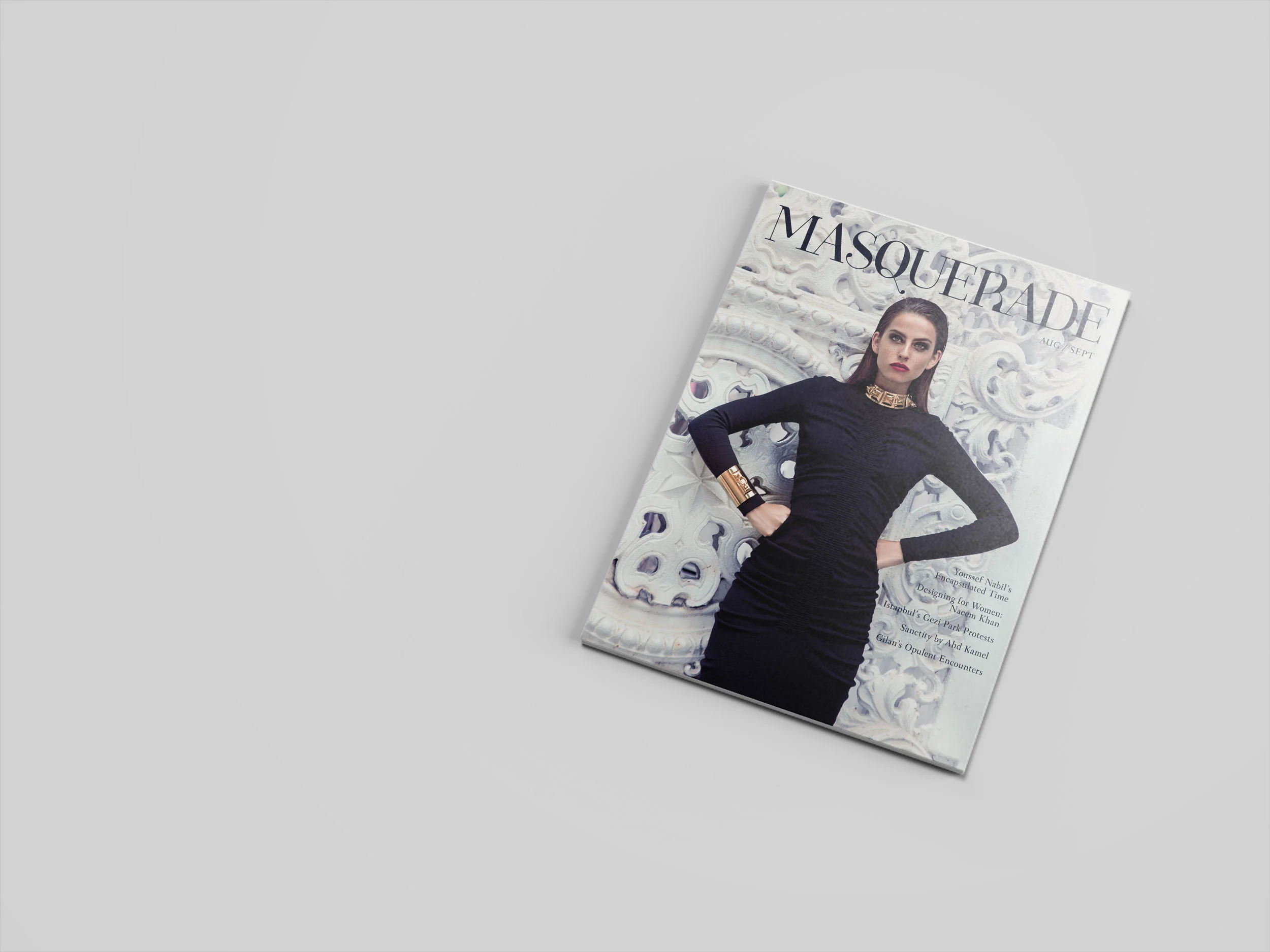 The cover of the August September Masquerade Magazine shows a woman wearing black holding a power pose